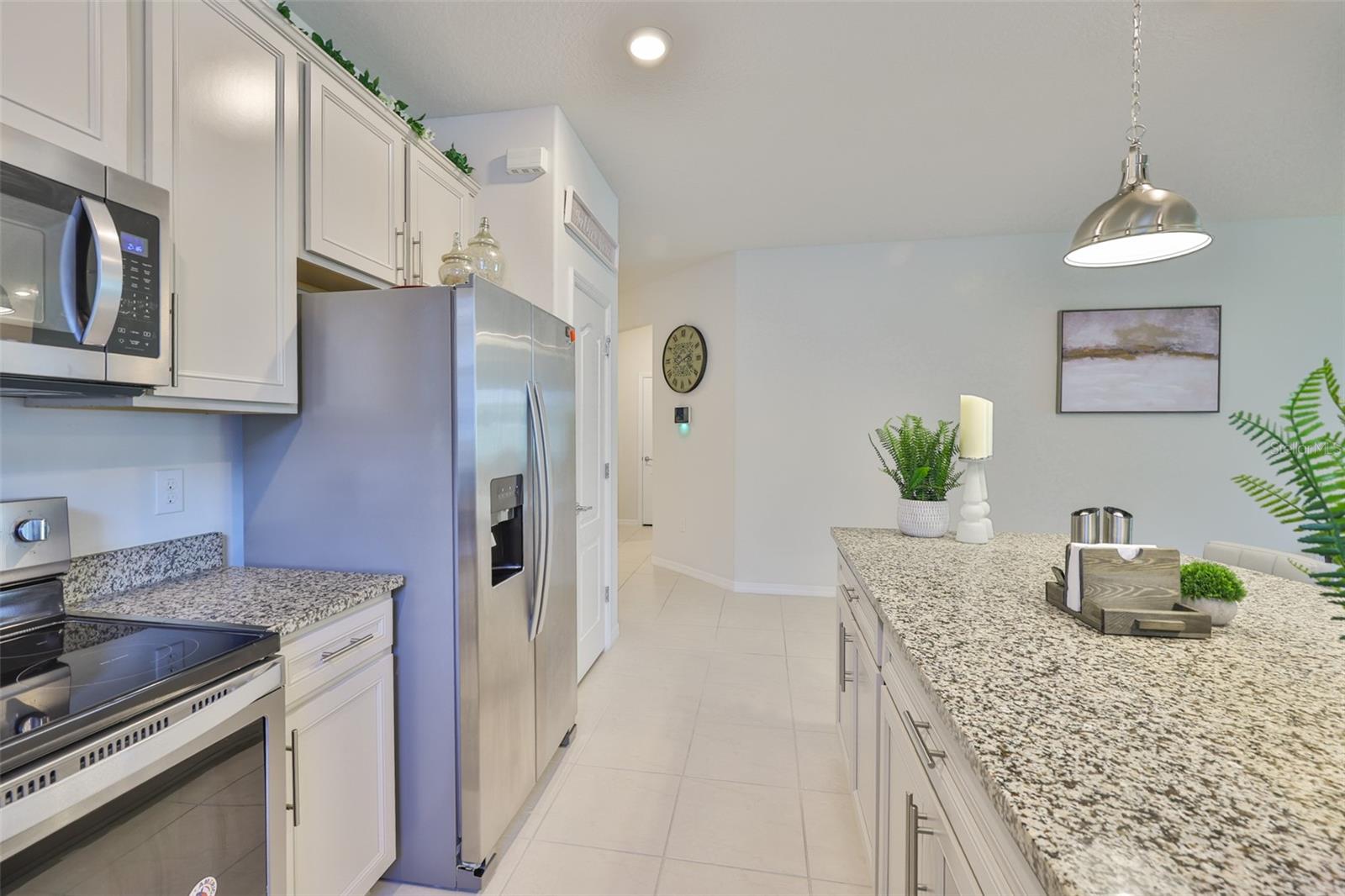 LARGE KITCHEN ISLAND WITH EXTRA STORAGE CABINETS.