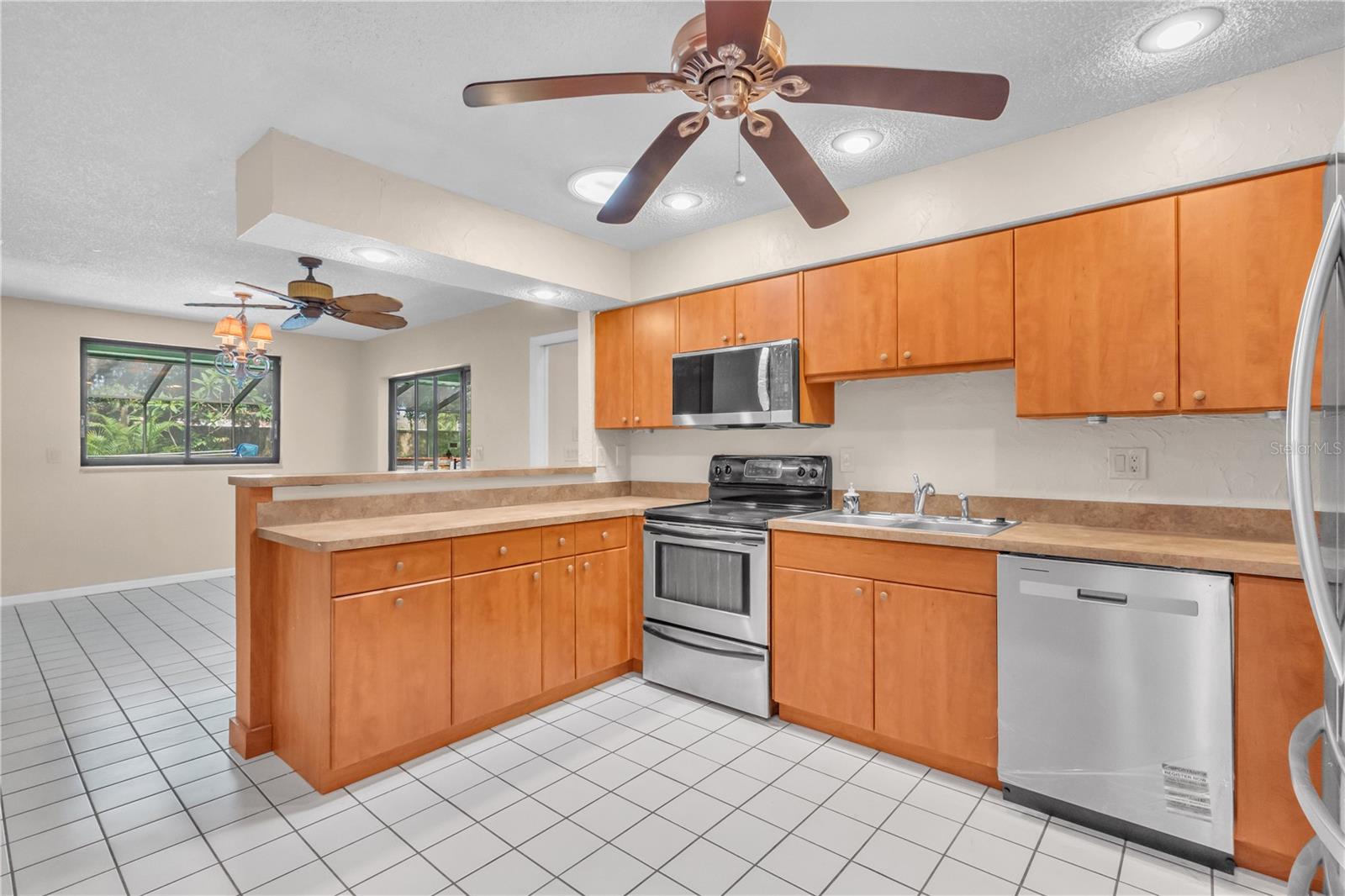 Spacious Kitchen with new microwave and dishwasher with Kitchen Nook and Breakfast Bar and exit to Lanai. Plenty of storage space in the cabinets and a Solar Tube to brighten the space.