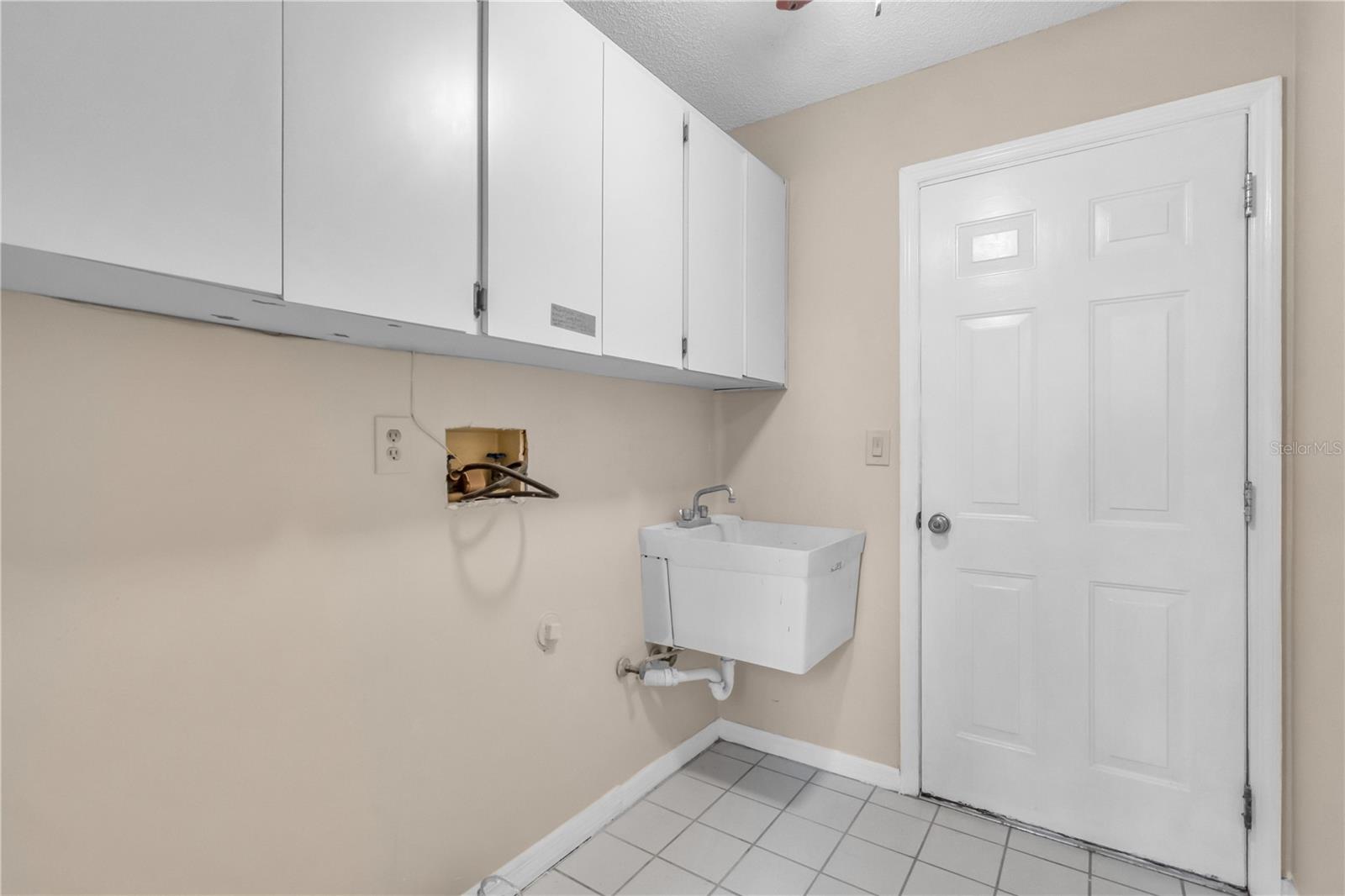 Laundry Room with sink and exit to Garage.