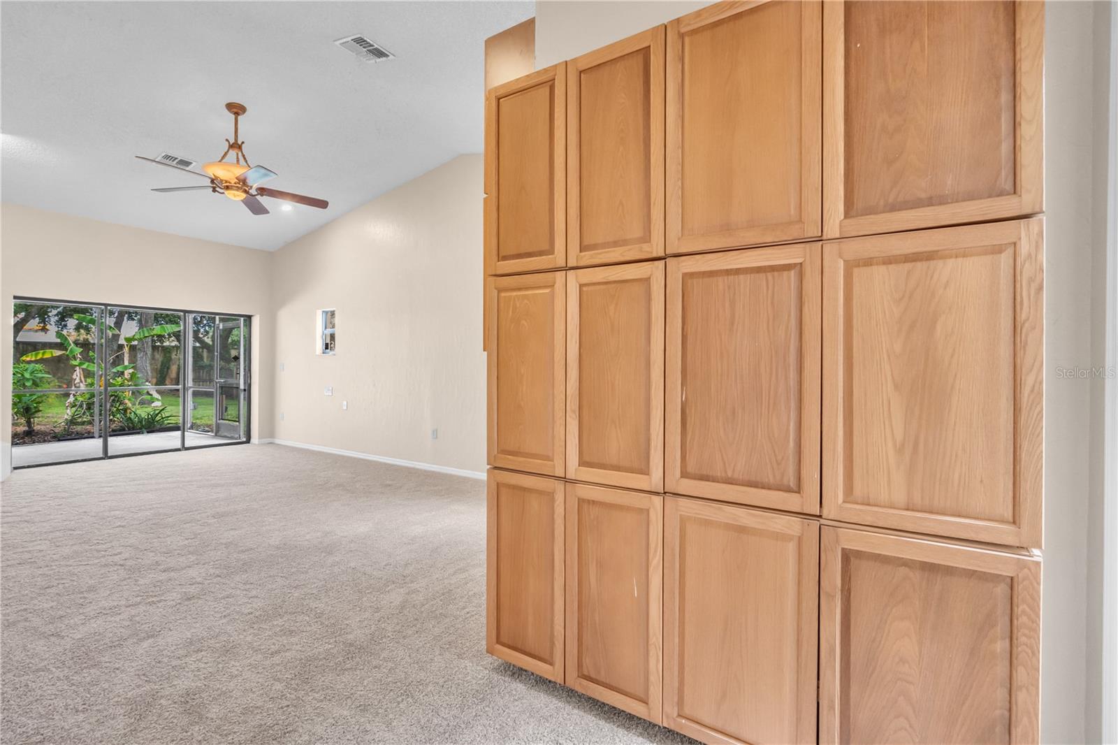 Spacious Master Bedroom with plenty of storage, ceiling fan, new carpet, and exit to Lanai and Pool.