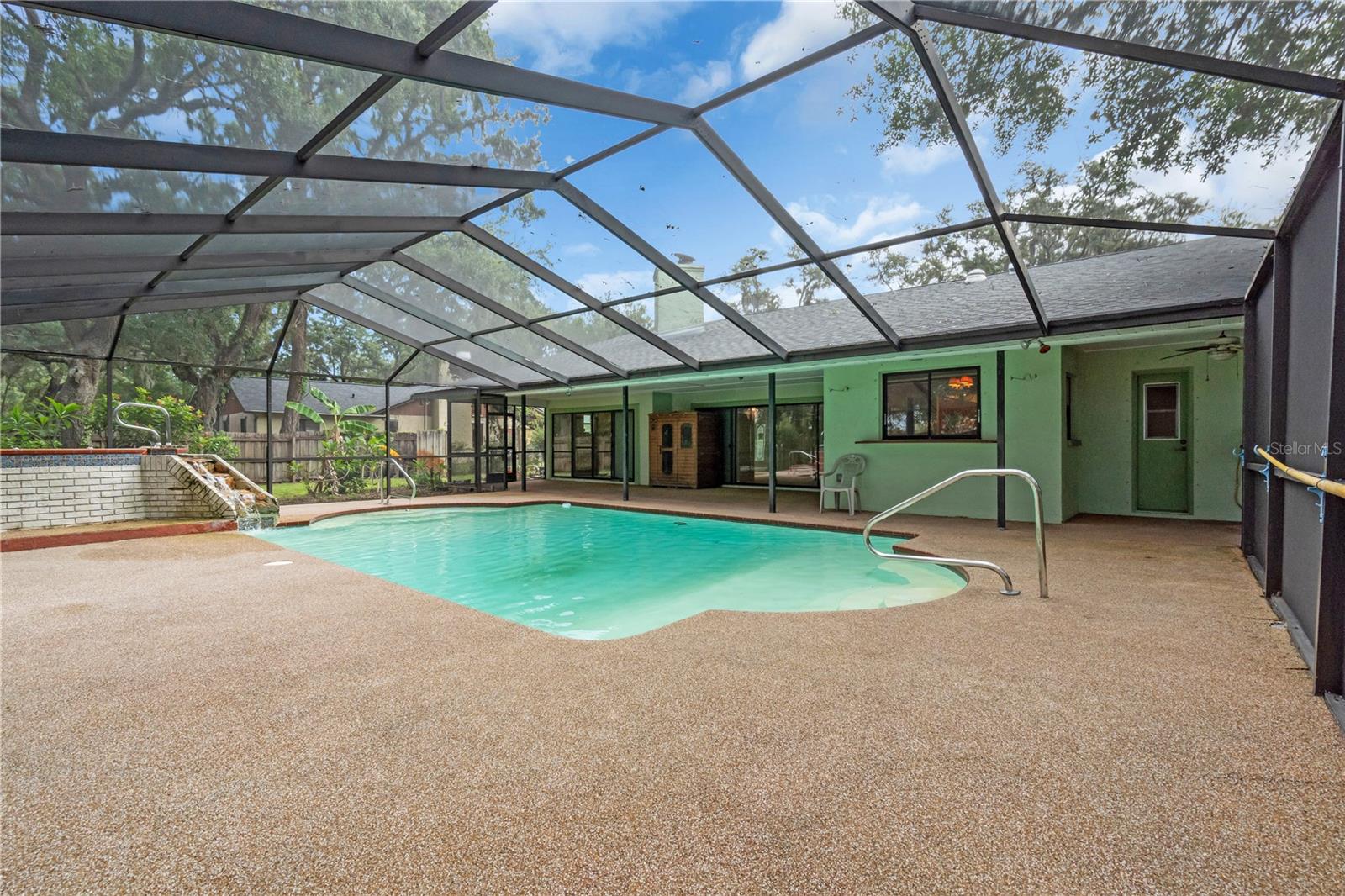 View of pool, sauna, and patio space.....all enclosed. Patio was just re-screened.