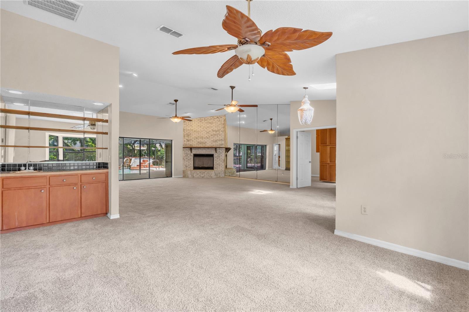 Wet Bar, Formal Dining Room, Great Room with ceiling fans and one of two fireplaces
