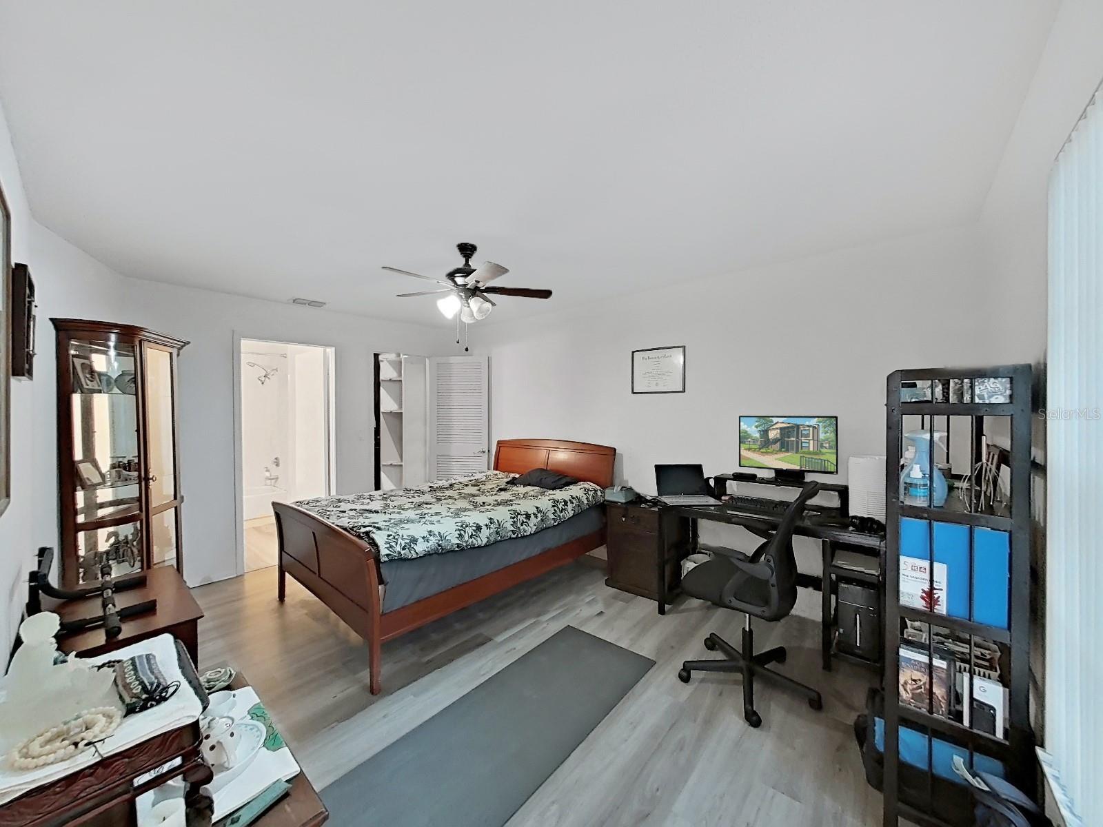 Primary Bedroom with open doors to bathroom and closet.