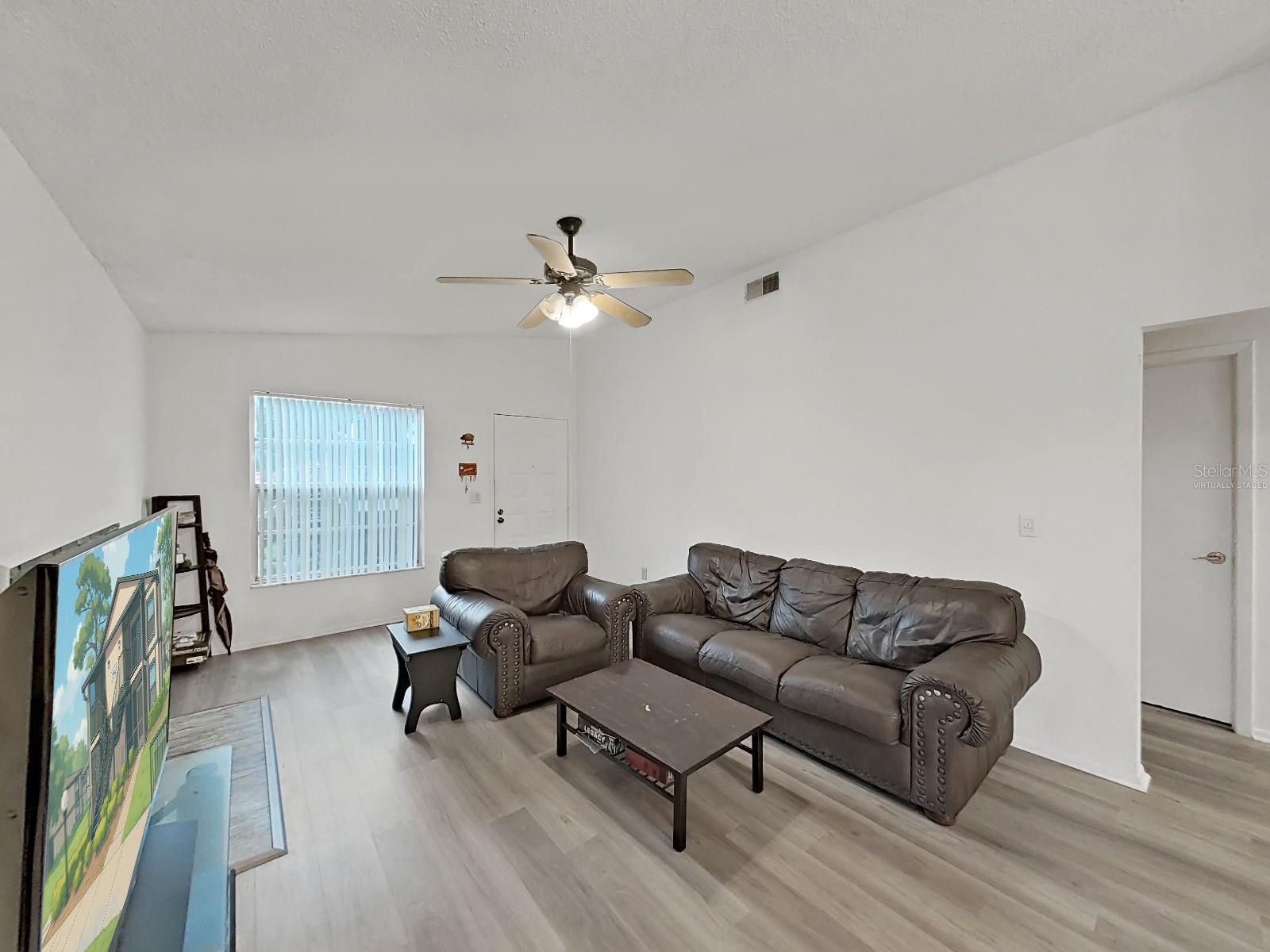 Living Room - Virtually staged items are:  TV Screen, and Corner Shelve.  TV is real.