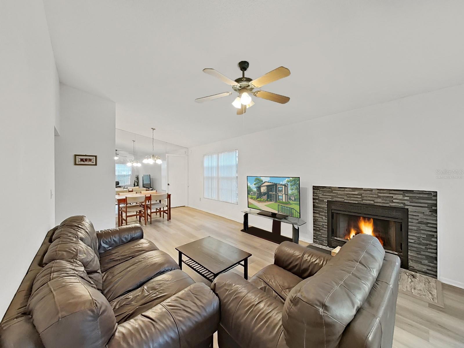 Living Room - Virtually staged items are:  Fire, TV Screen.  Fireplace and TV  are real.
