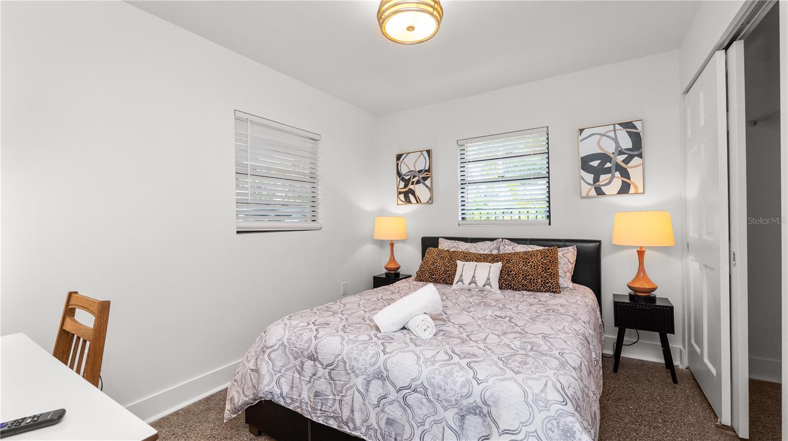 Bedroom #2 with centric paintings & lamps