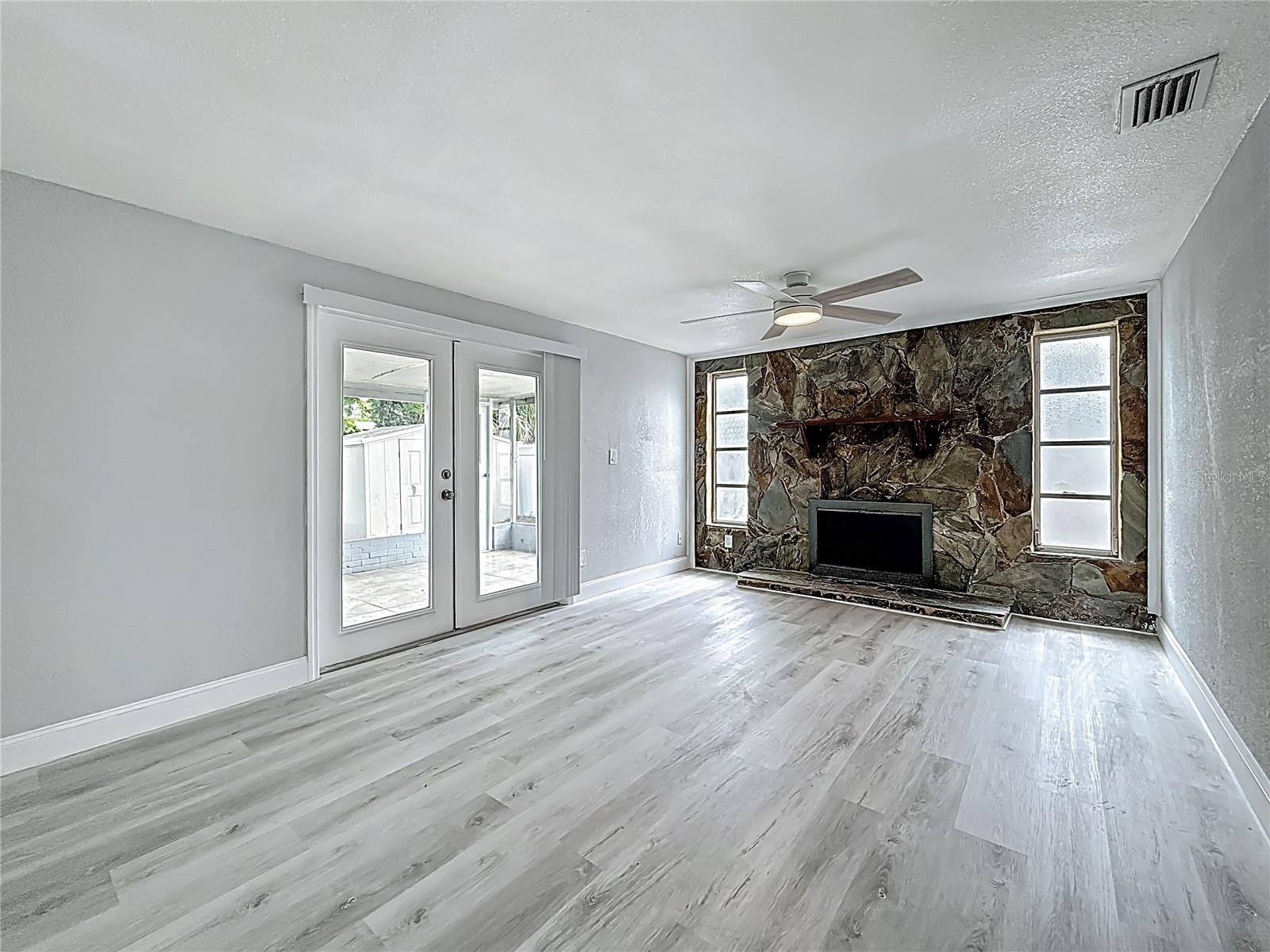 Primary Suite with cozy fireplace with private bath and French Doors.  The spacious primary suite also offers flexibility and can easily serve as an additional living area, bonus room, or game room if desired.