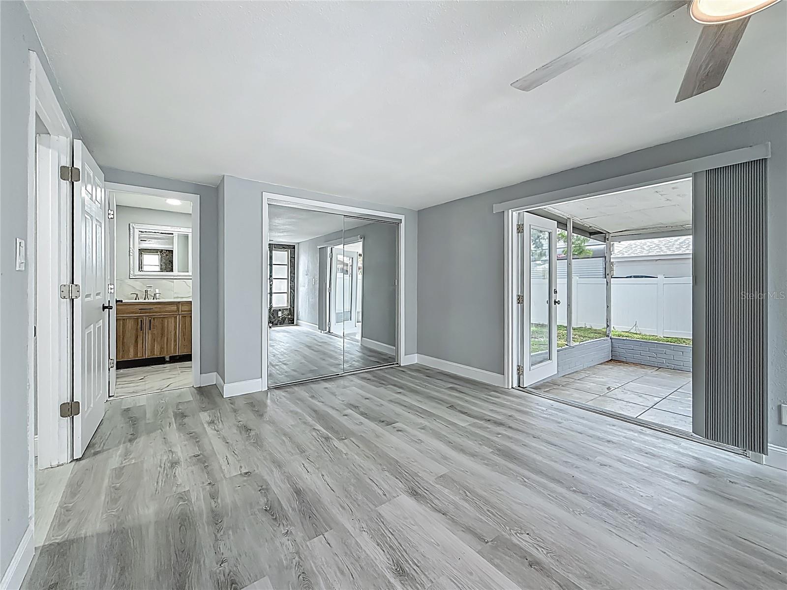 Primary Suite with cozy fireplace with private bath and French Doors.  The spacious primary suite also offers flexibility and can easily serve as an additional living area, bonus room, or game room if desired.