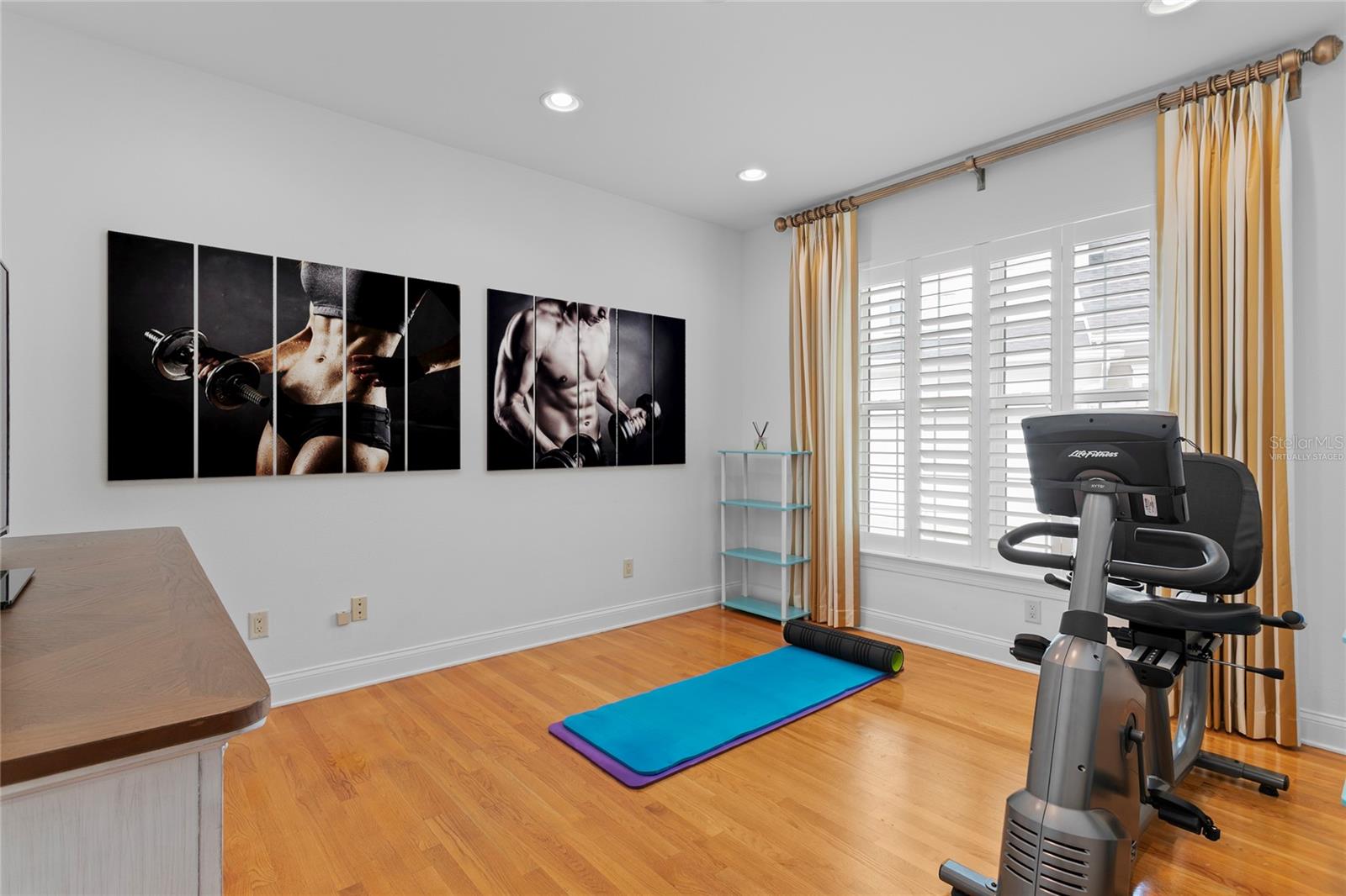 There is also a dedicated space for a gym or office on the first floor. This is a virtually staged photo of accessories