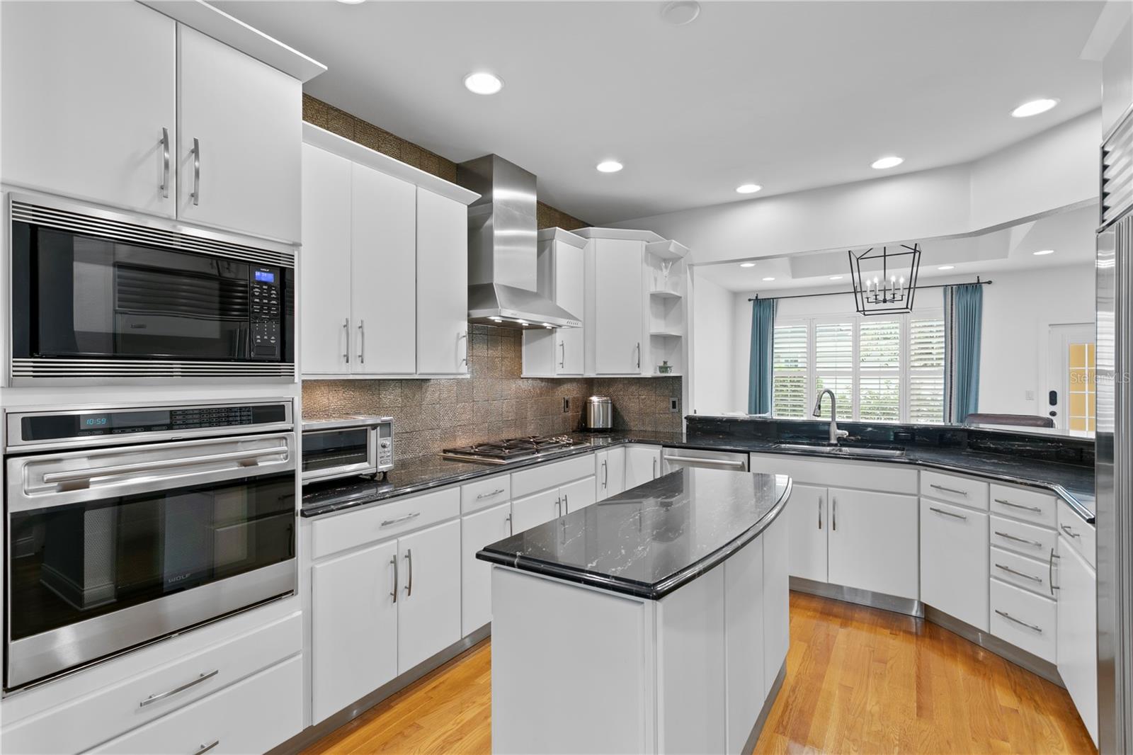 The Chef’s delight kitchen with unique center island and commercial grade Wolf and Subzero appliances
