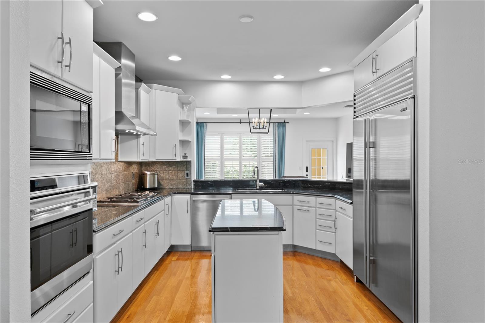 The open layout between the kitchen and family room lets you stay part of the conversation while preparing meals.