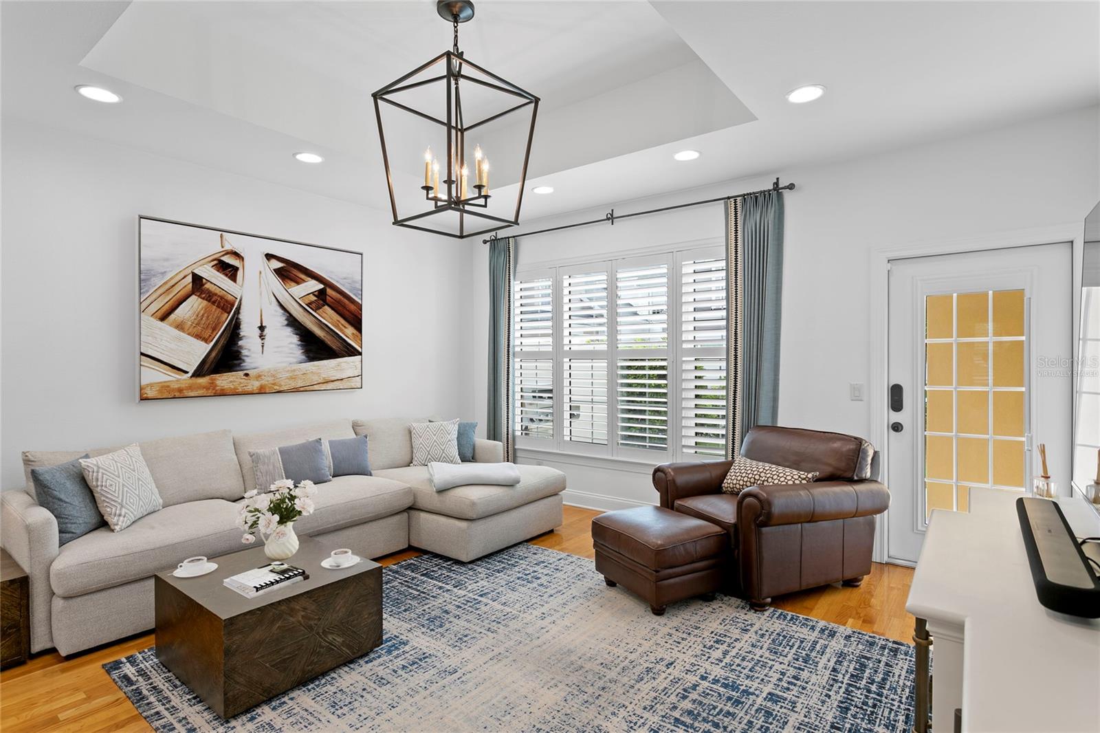 This open and bright family room is filled with natural light and offers a warm, welcoming atmosphere perfect for everyday living and entertaining. This is a virtually staged photo of accessories
