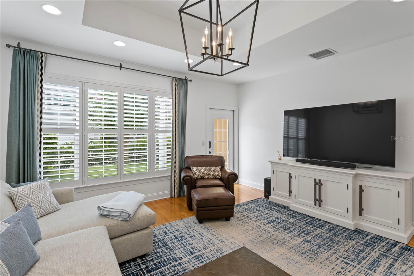 The open and bright family room has seamless access to the outdoor patio