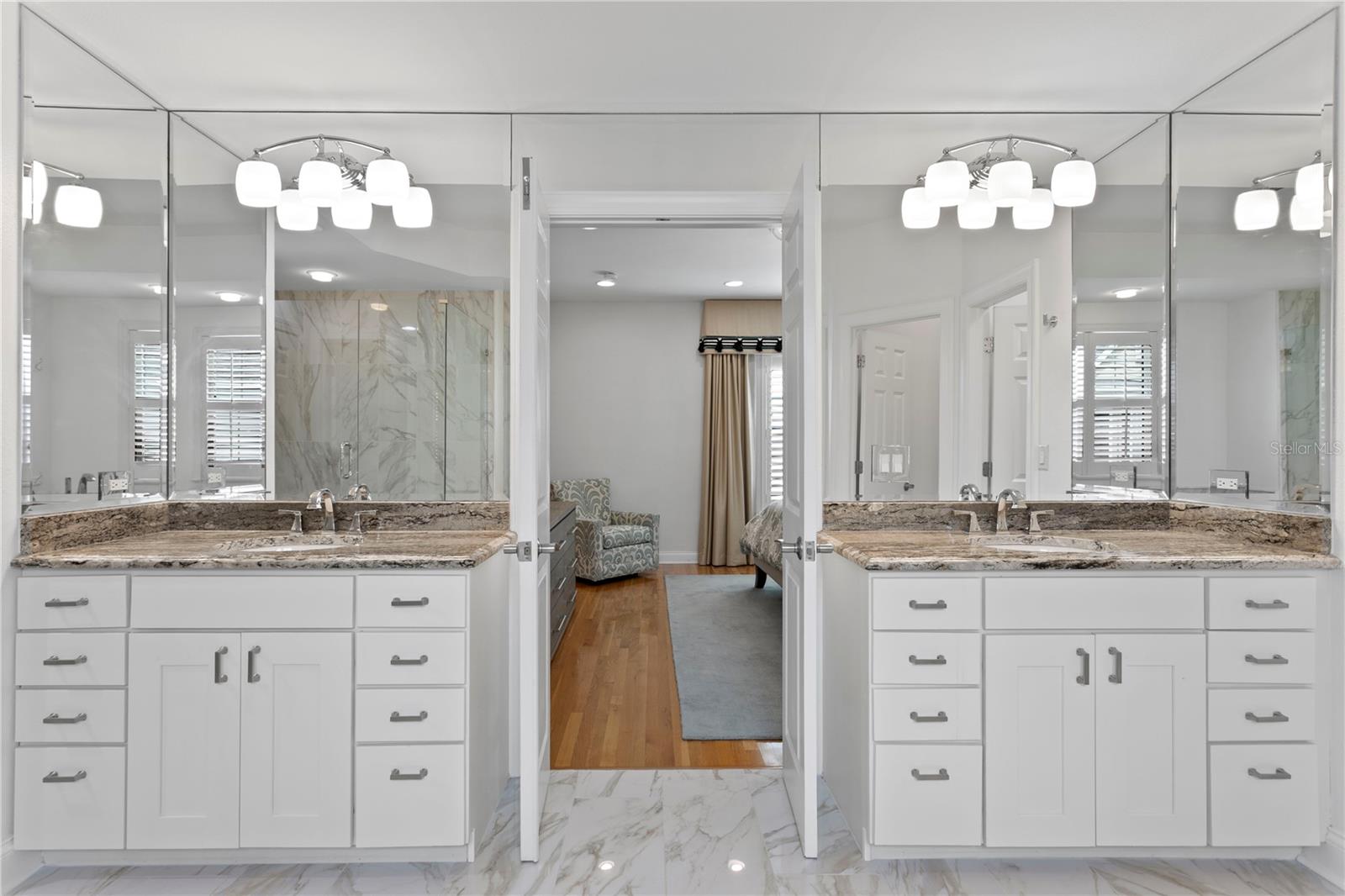 This beautifully renovated primary bath boasts double vanities and generous space, designed for comfort and convenience with room to move freely.