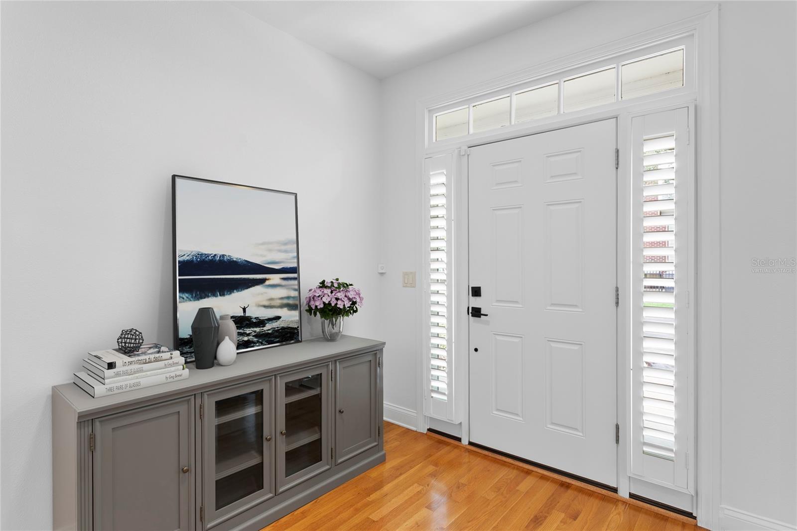 As you step inside you are greeted with a lovely front entryway. This is a virtually staged photo of accessories