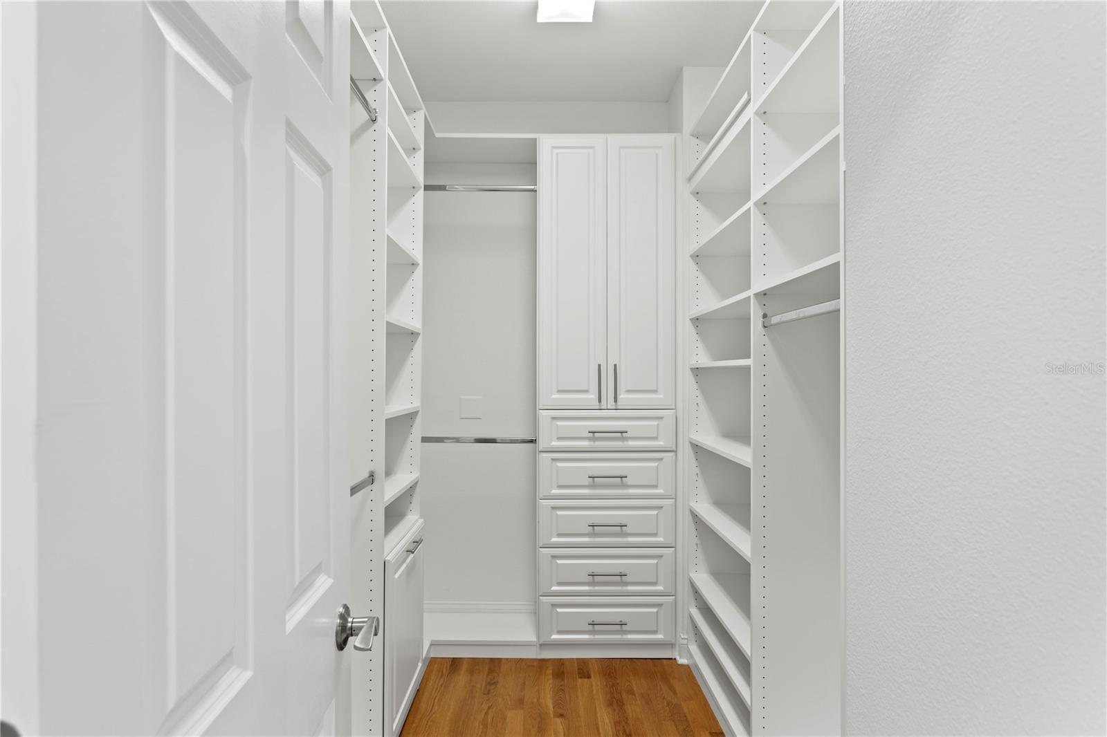 A large walk-in closet offers ample space to keep everything organized and within reach.