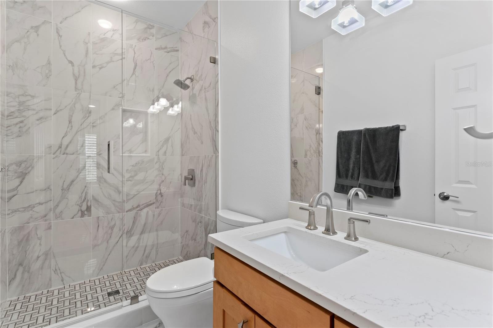 A stylishly updated en suite bathroom complements the third bedroom.