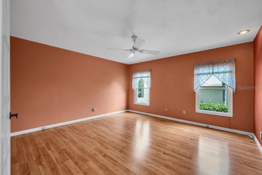 Primary bedroom with laminate flooring