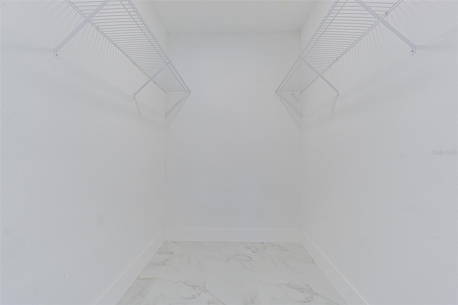 Primary bedroom walk in closet