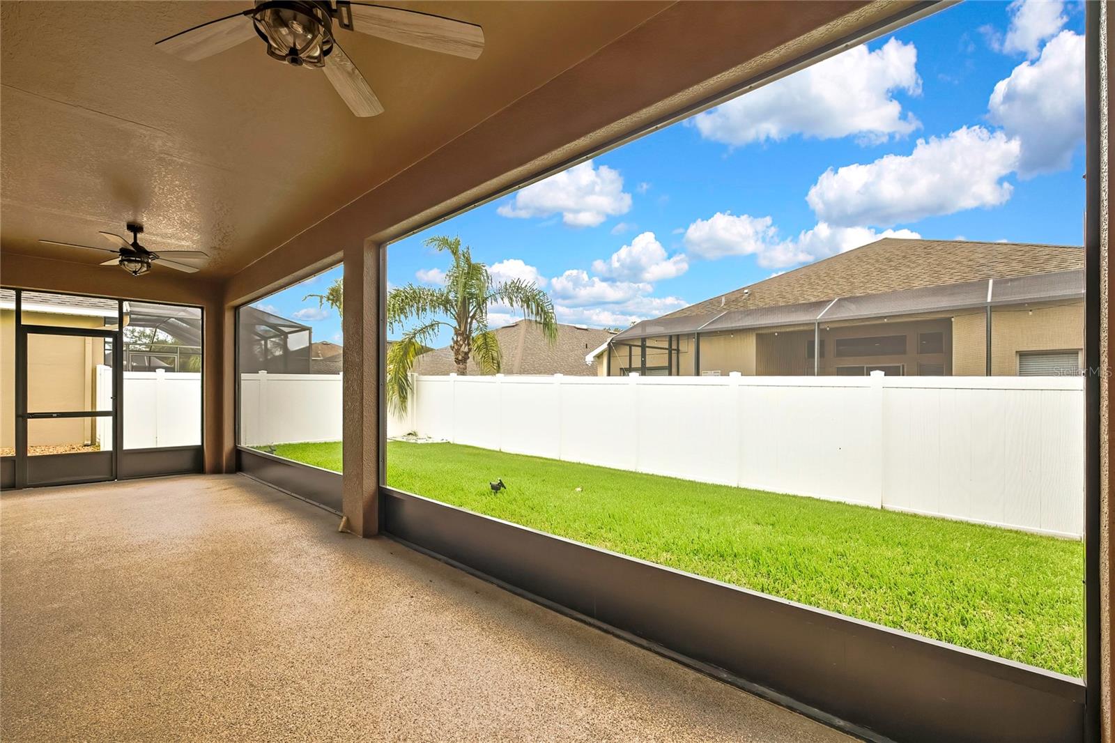 angle view of back yard from screened lanai