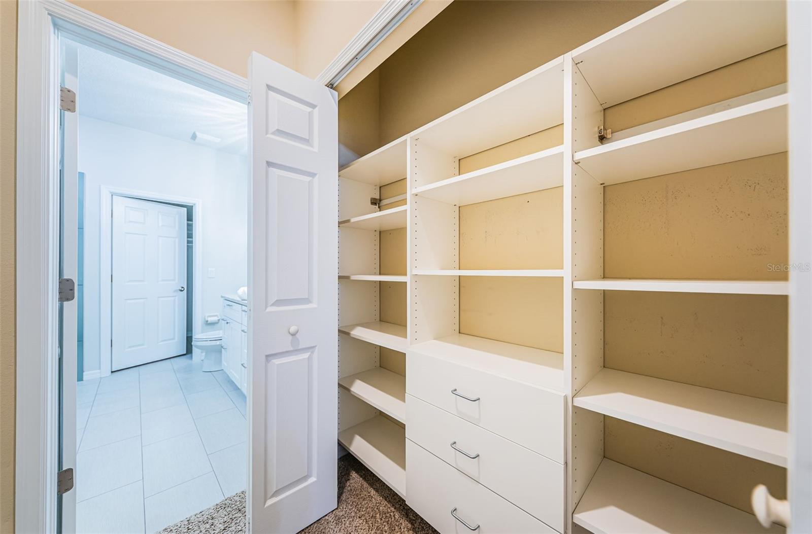 Walk in closet primary bedroom