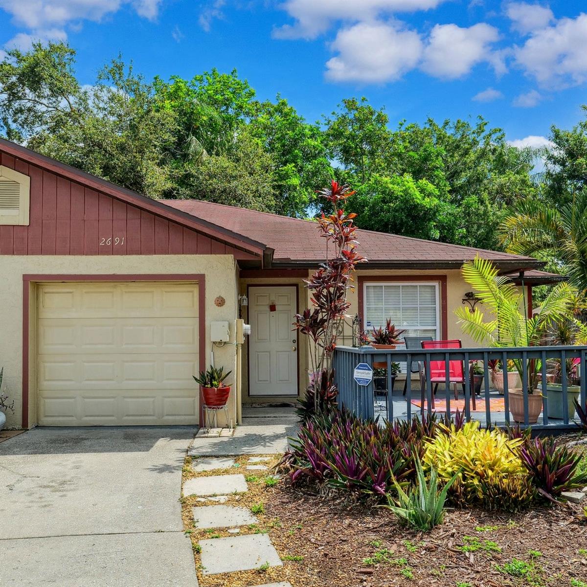 Beautiful landscaping and a generous deck welcome you home!