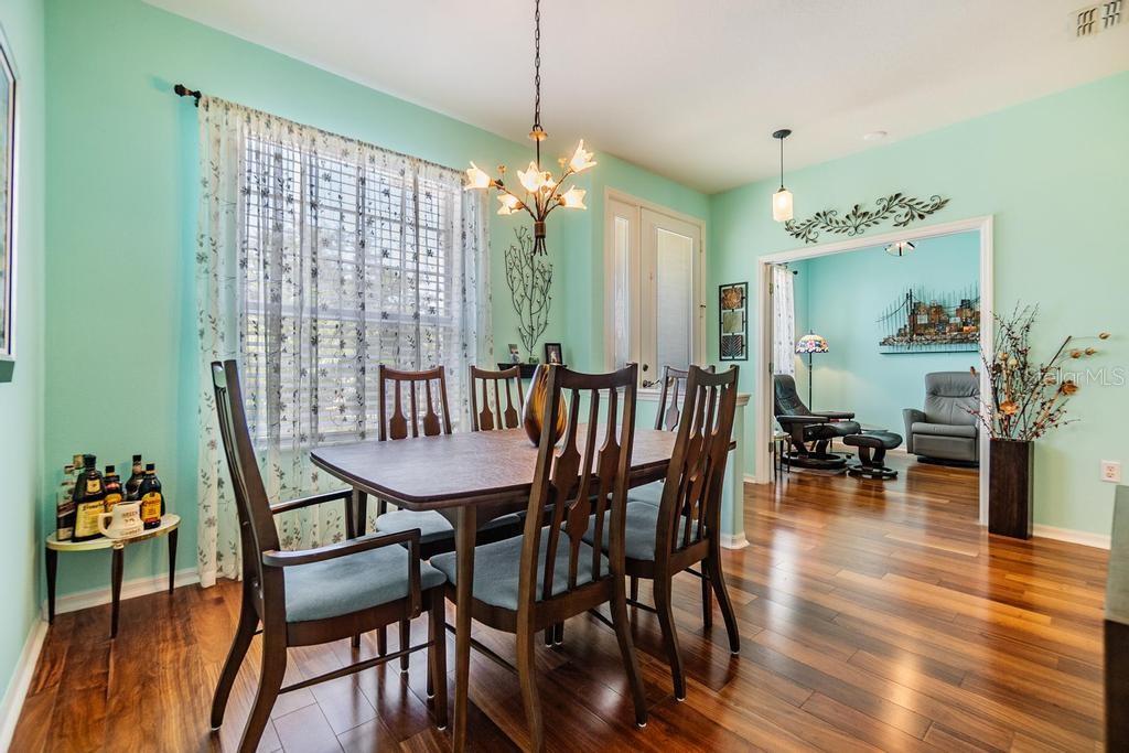The formal dining room is situated just off the front entry way with doorway to kitchen, pony wall and window for a bright open dining atmosphere.