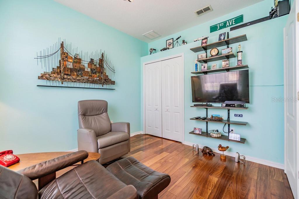 . The fourth bedroom is positioned at the front of the home with double doors, making it ideal for a home office, guest space, or den.