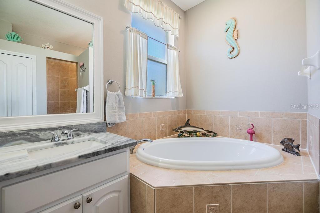 The enviable ensuite bath features a double sink vanity with ample storage and counter space, a soaking tub, walk-in shower, linen closet, and private water closet.
