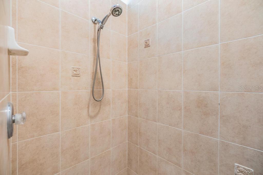 The enviable ensuite bath features a double sink vanity with ample storage and counter space, a soaking tub, walk-in shower, linen closet, and private water closet.
