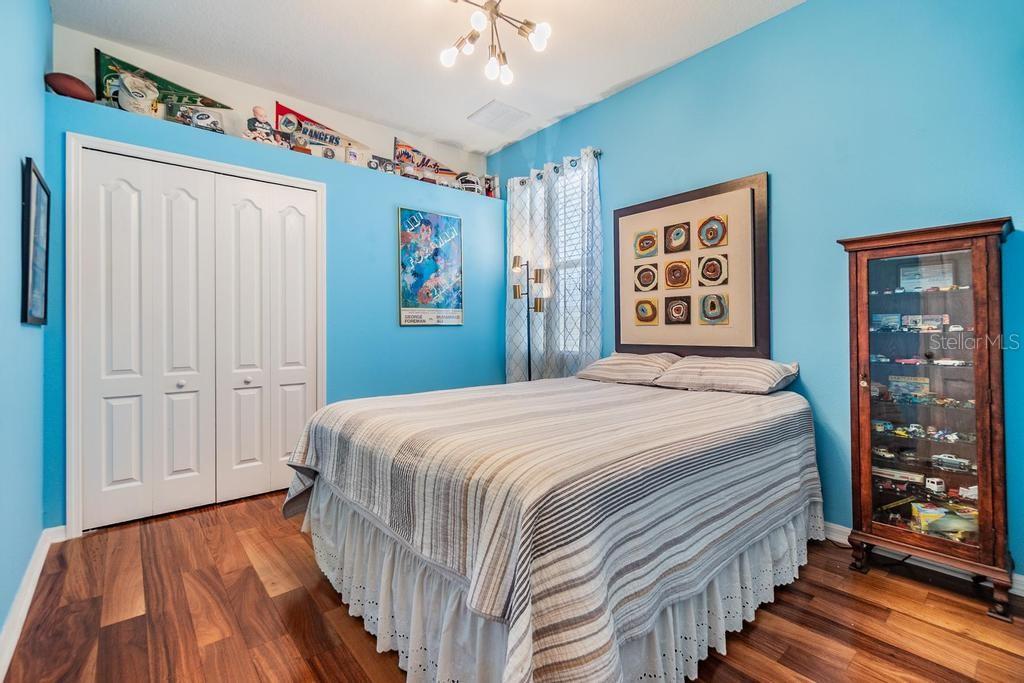 The second bedroom offers a wall closet, beautiful engineered hard wood floors, and a charming ceiling alcove.