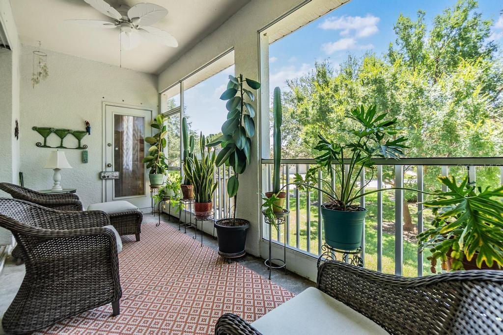 Step outside to enjoy the peaceful screened patio with views of mature trees, open green space, and a partial pond—an ideal setting for relaxing and enjoying Florida’s year-round sunshine. A newly installed staircase (2025) provides easy access to the backyard.