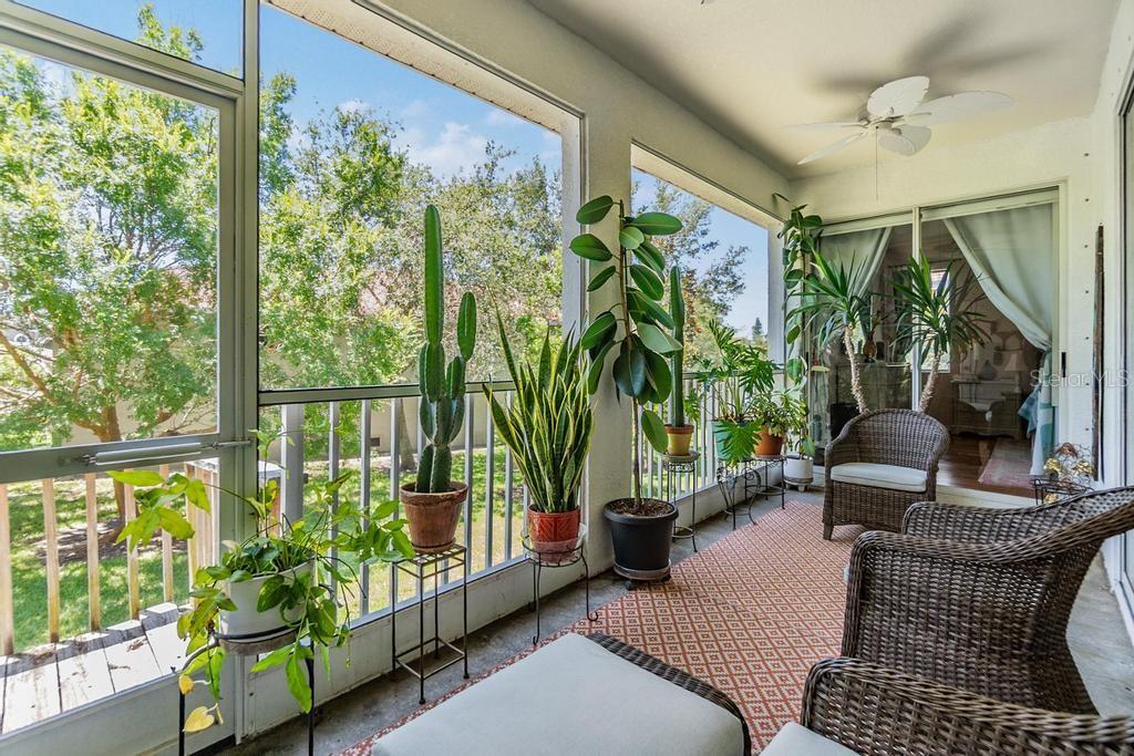 Step outside to enjoy the peaceful screened patio with views of mature trees, open green space, and a partial pond—an ideal setting for relaxing and enjoying Florida’s year-round sunshine. A newly installed staircase (2025) provides easy access to the backyard.