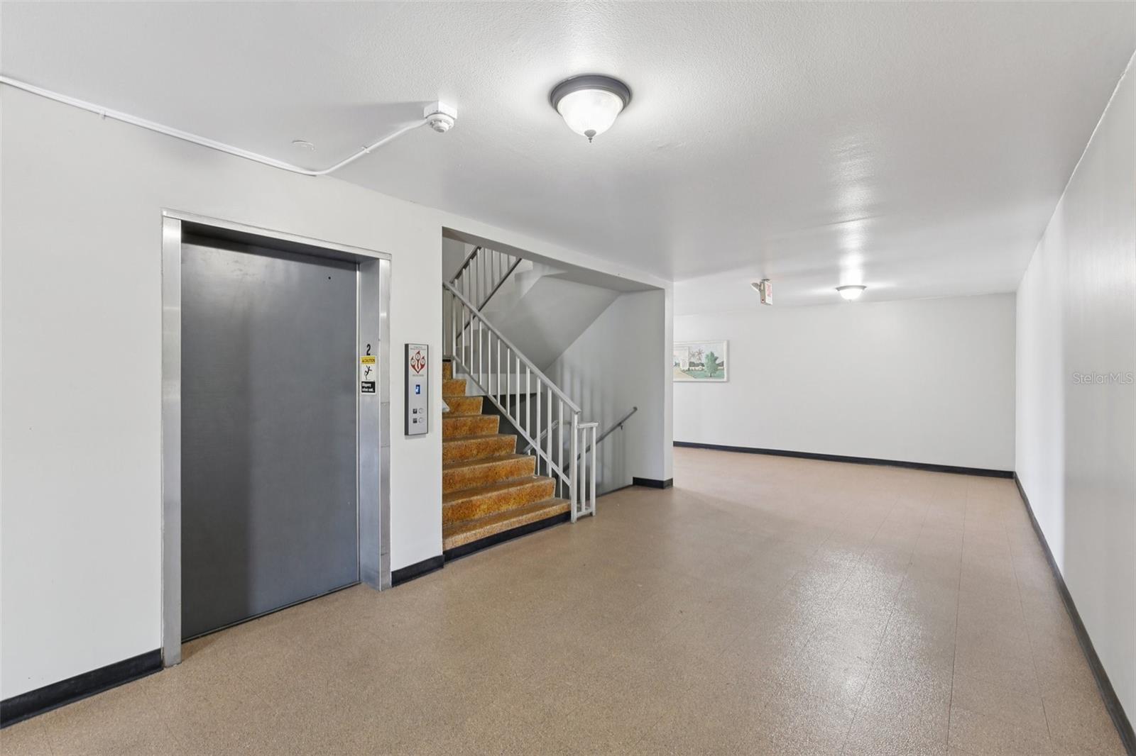View of elevator and stair access just outside of this unit.