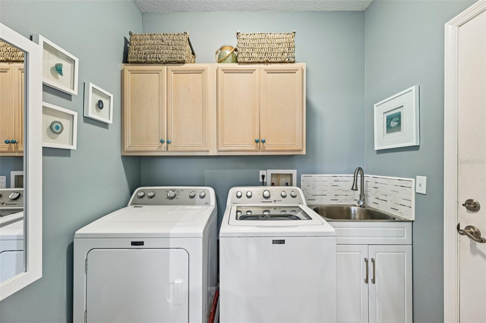Laundry room with storage and utility sink