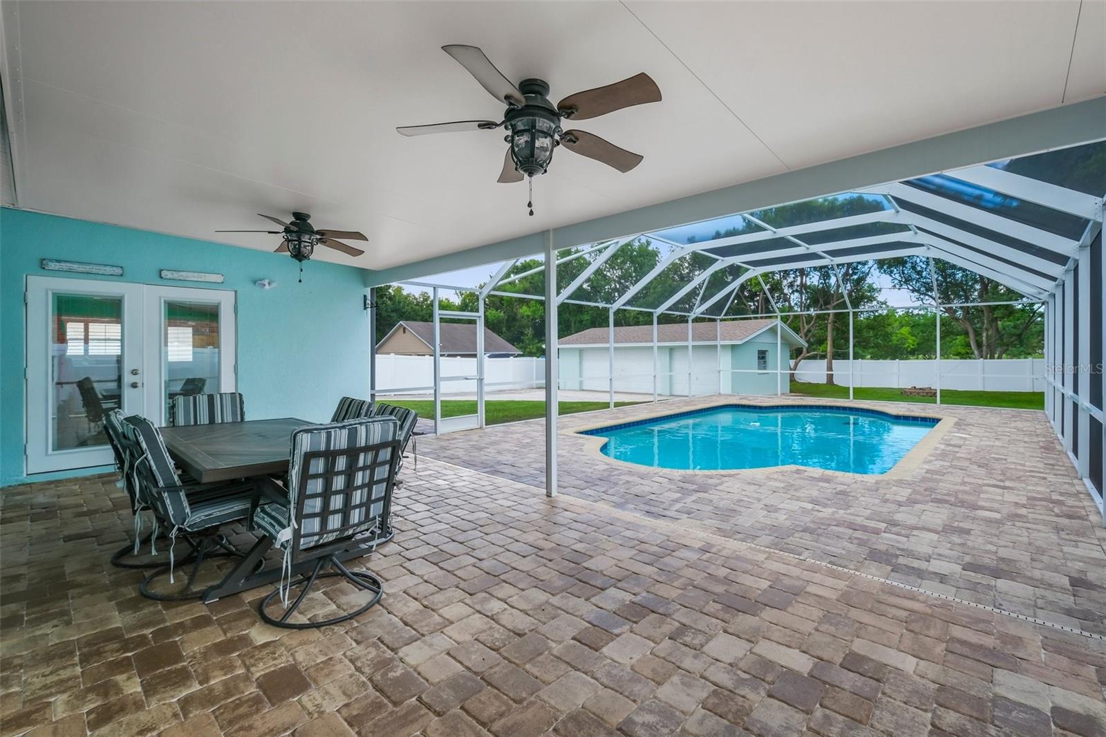Party Porch with the brick paver deck and private pool with screened enclosure.