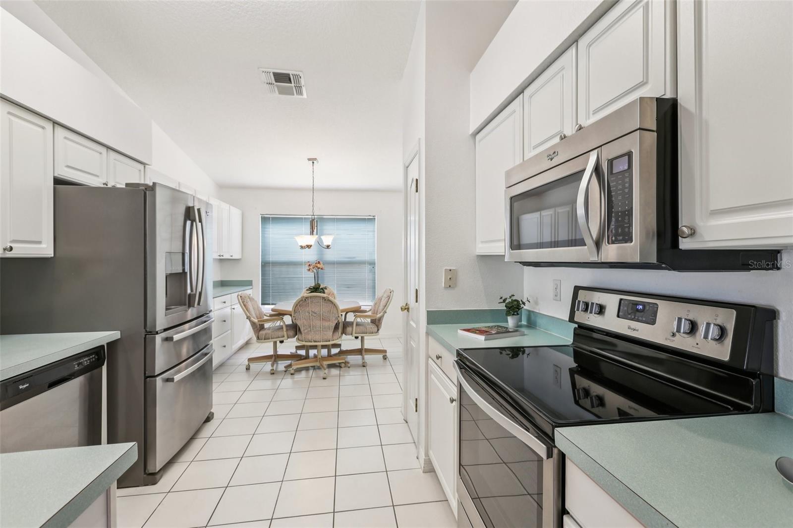 Large, eat-in kitchen with stainless steel appliances