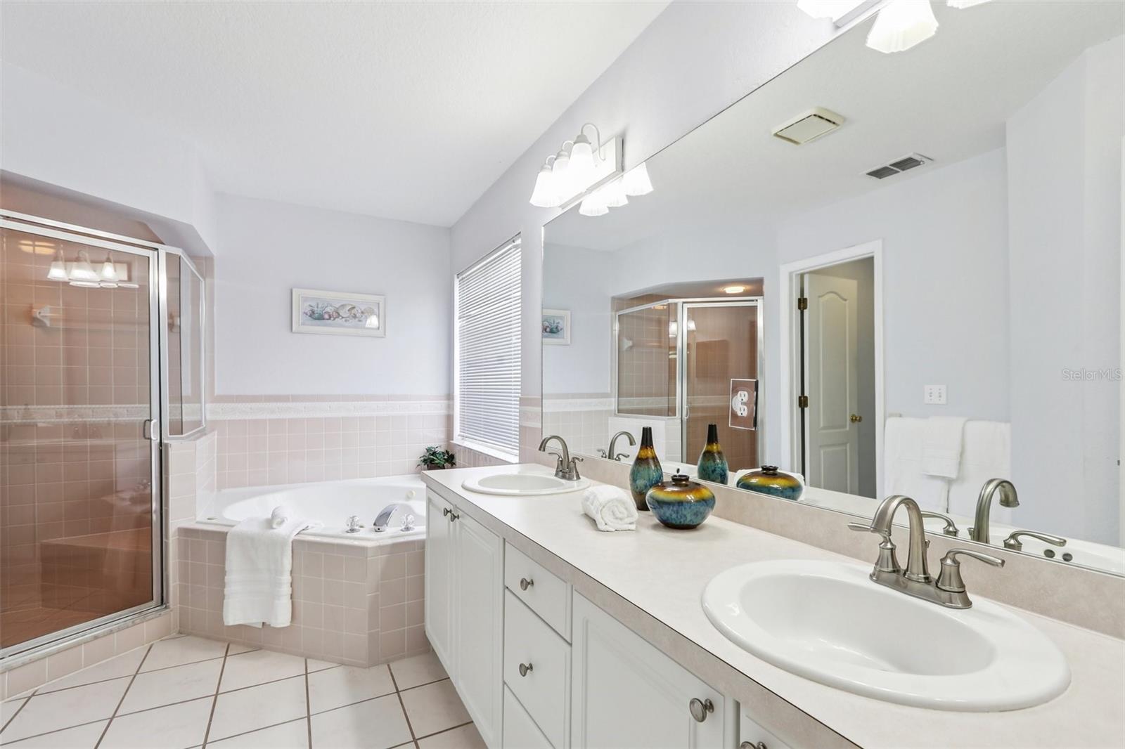 Primary bathroom: separate tub and shower, dual sinks, water closet, linen closet