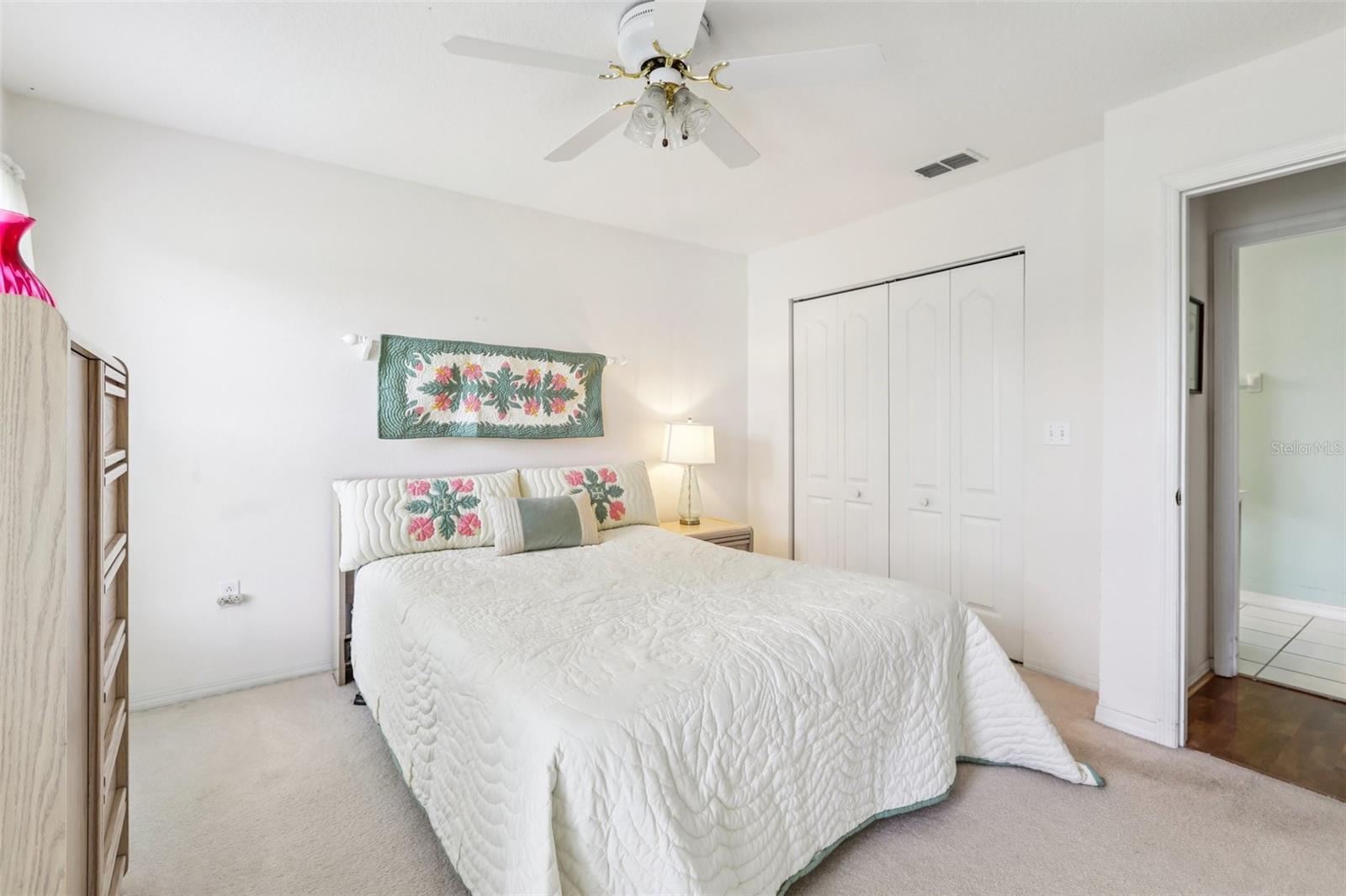 Secondary bedroom with view to secondary bathroom across the hall