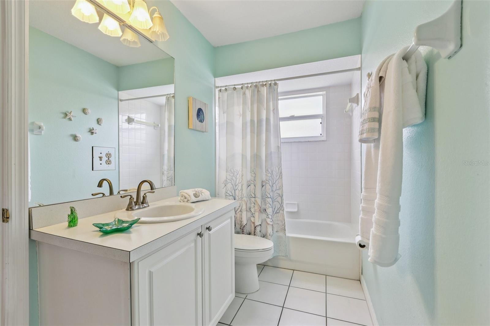 Secondary bathroom features shower/tub combo and linen closet