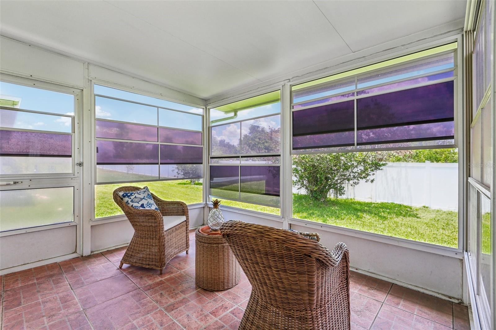 Screened lanai with view to backyard fence