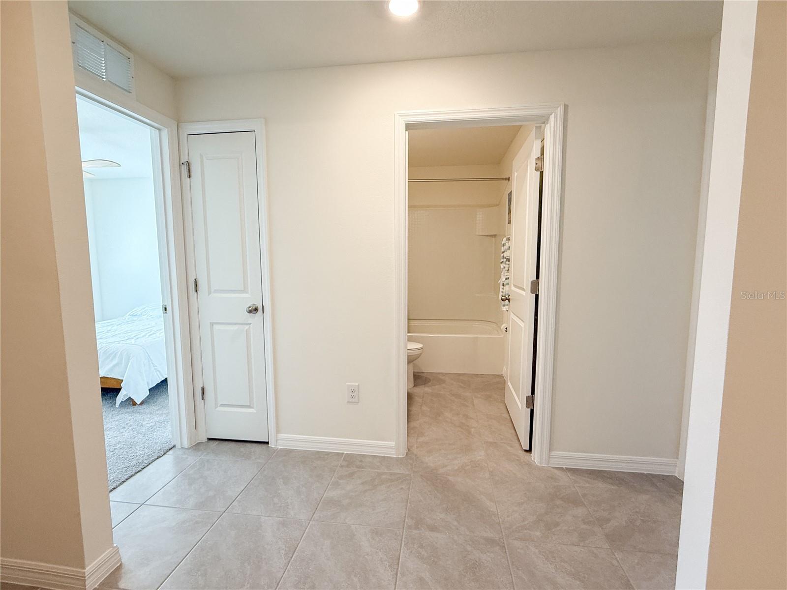 Second bedroom, shared bathroom, and third bedroom