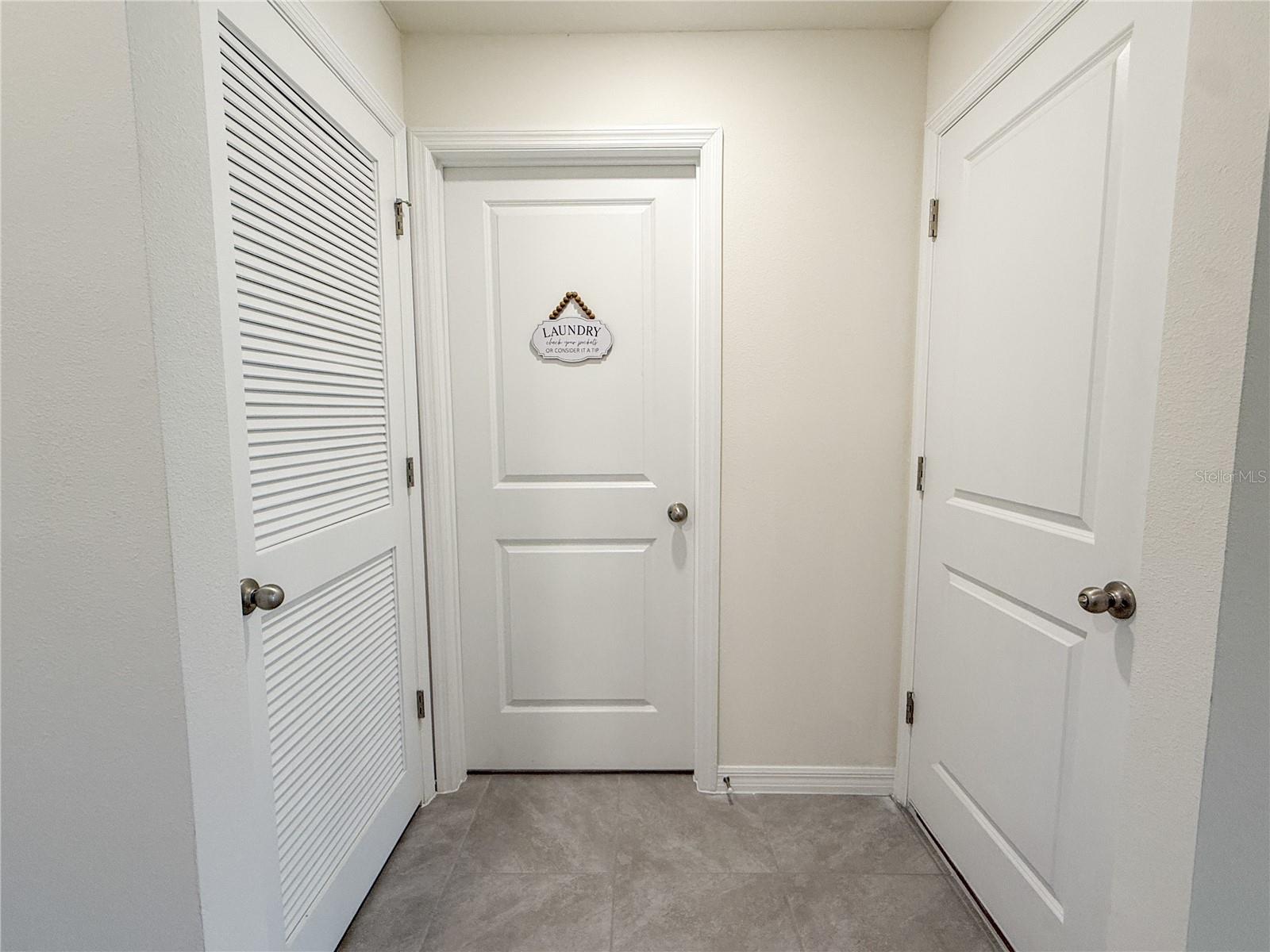 Utility closet, laundry room, and garage entrance