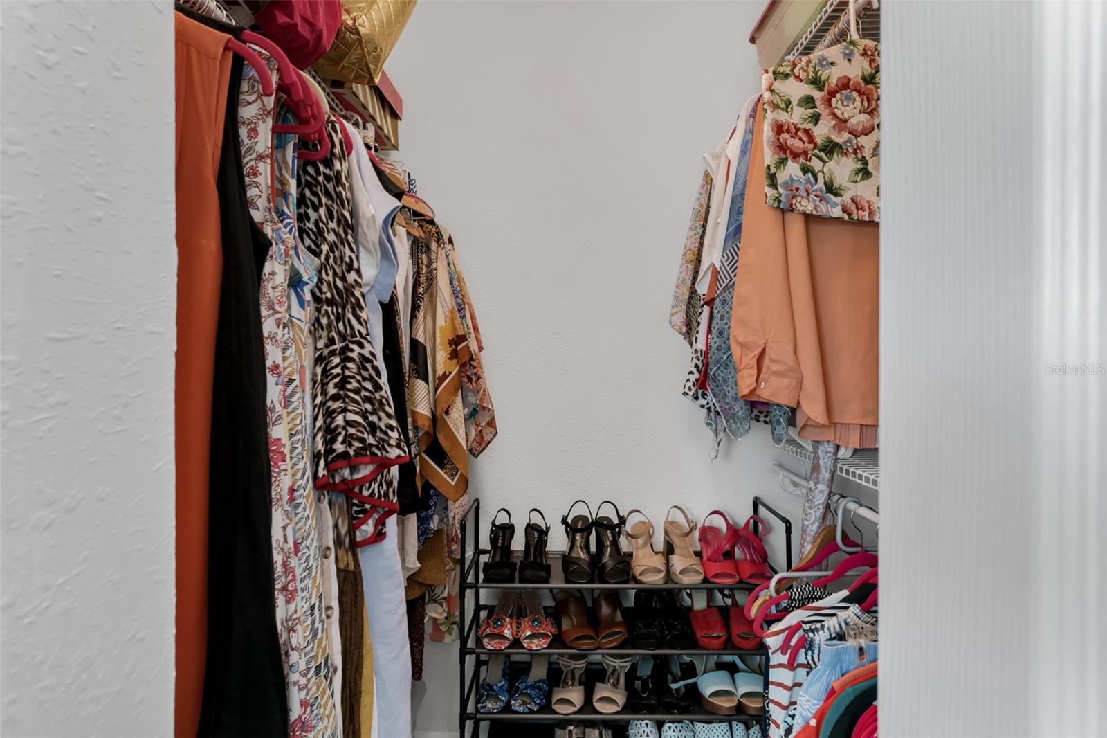 Primary bedroom walk in closet