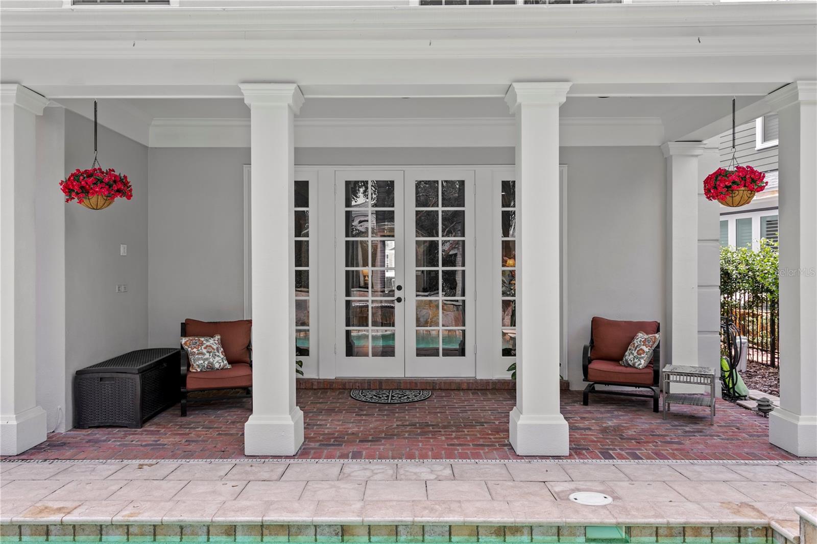 Relax on the shaded, covered back porch and take in the lively poolside views.