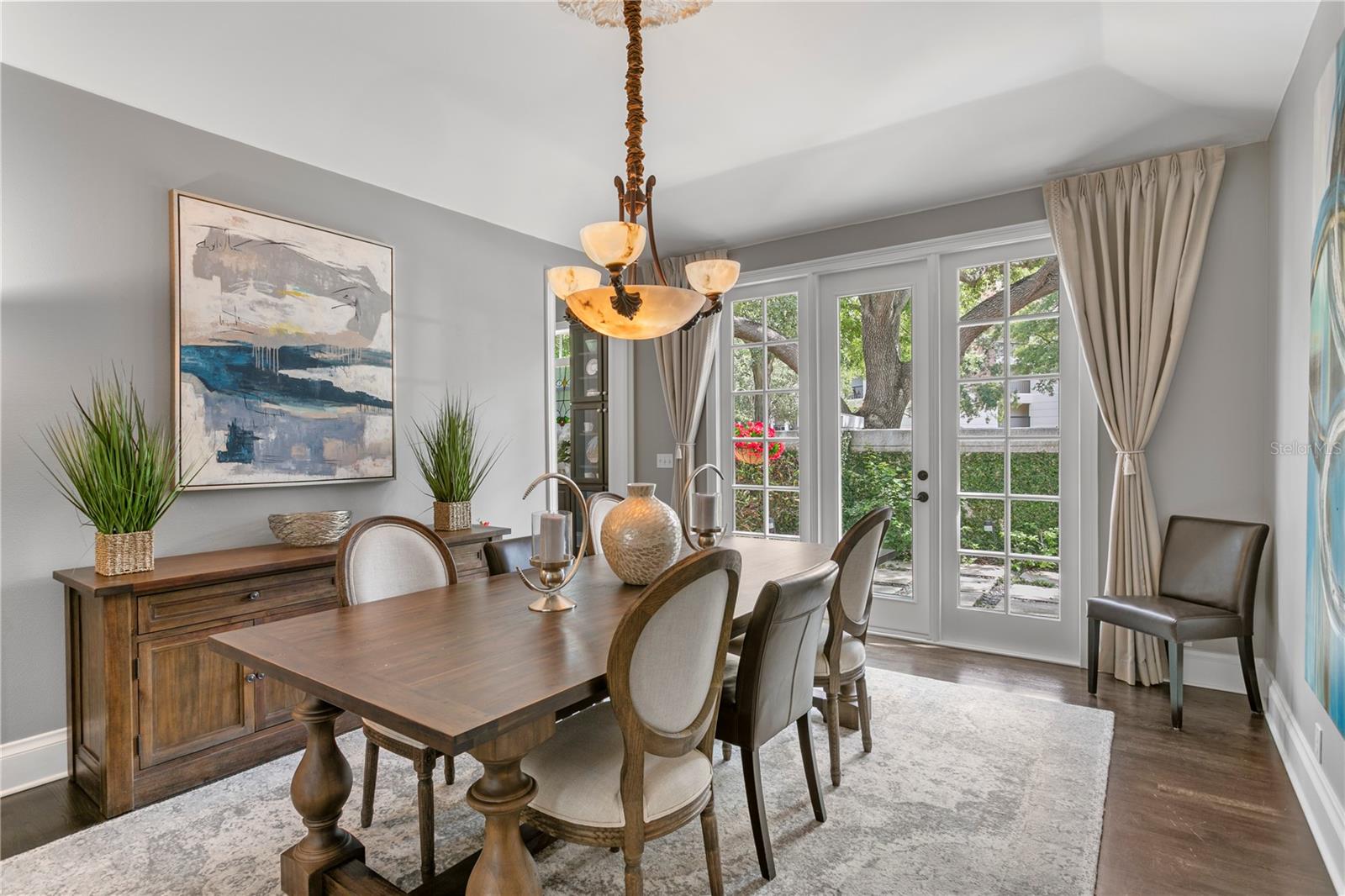 The dining area connects to a peaceful side yard, extending your living and dining space into the outdoors.