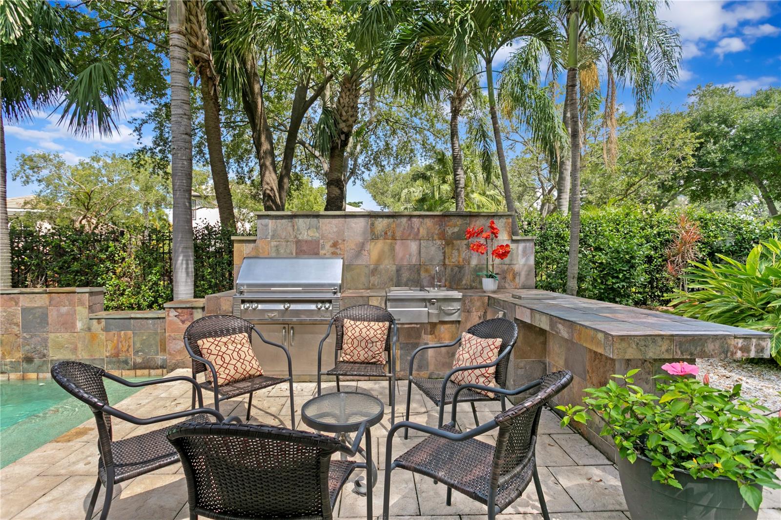 Enjoy views of the outdoor kitchen and pool right from the informal dining area—definitely not a bad view!