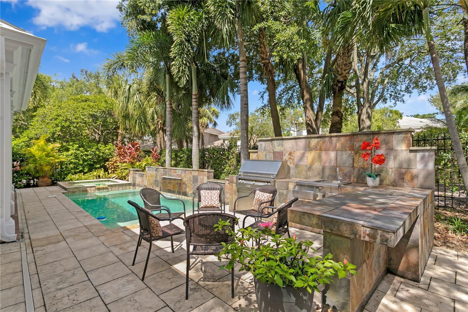 Enjoy views of the outdoor kitchen and pool right from the informal dining area—definitely not a bad view!
