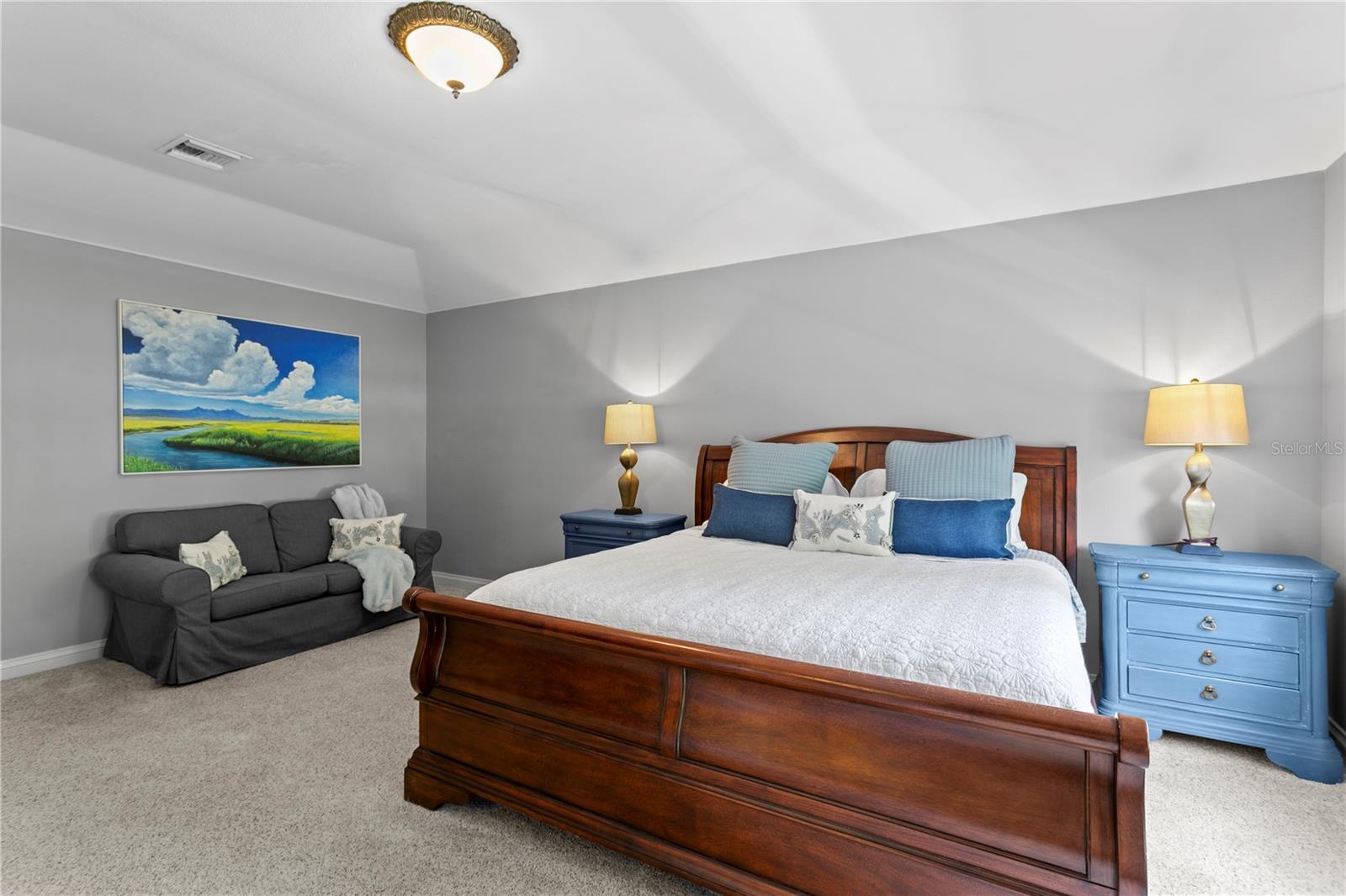 The spacious primary retreat large enough to accommodate a sofa and sitting area