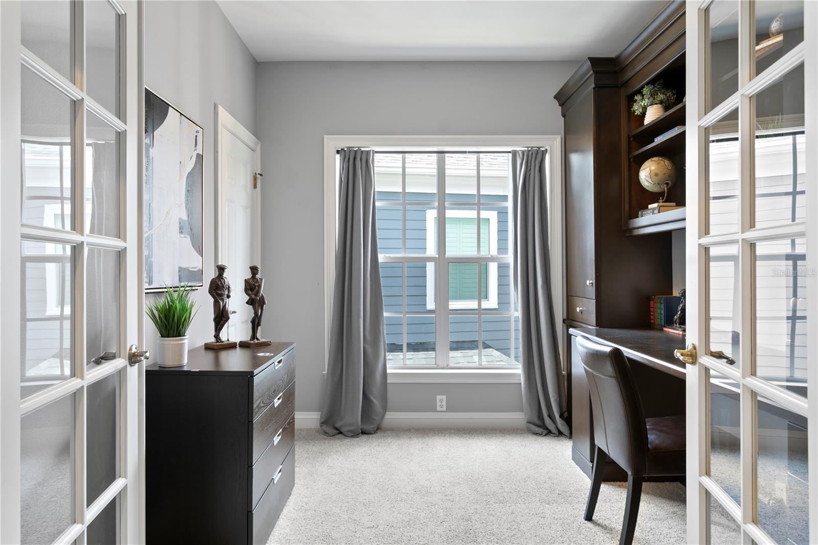 Currently utilized as a home office, the fourth bedroom provides a quiet and flexible workspace.
